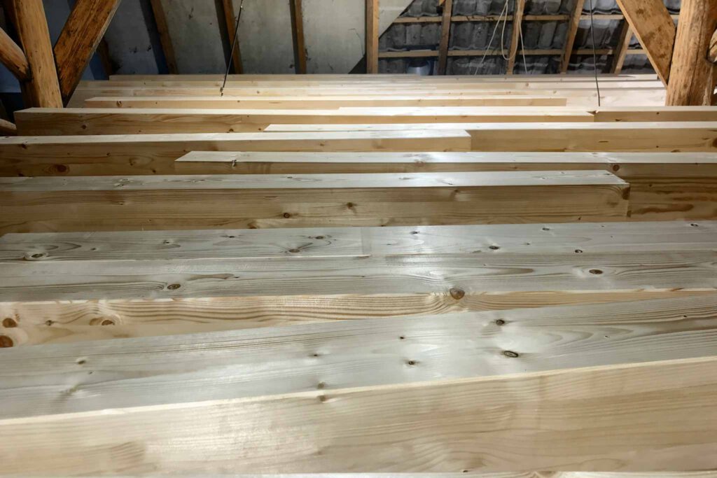 wooden beams waiting to be placed in a ceiling